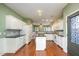 Spacious kitchen featuring white cabinets, granite countertops, and an island with wood floors at 5302 Silkwood Dr, Durham, NC 27713