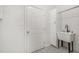 Bright laundry room with a basin sink, white cabinets, and decorative tile flooring at 5302 Silkwood Dr, Durham, NC 27713