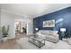 Staged living room with bright paint, carpet and view into an adjacent dining room at 5302 Silkwood Dr, Durham, NC 27713