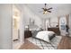 A spacious bedroom features neutral decor, ceiling fan, two windows, and an attached bathroom at 5302 Silkwood Dr, Durham, NC 27713