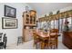 Charming dining area with a wooden table, decorative cabinet, and a large window that views the woods at 577 Woodbury, Pittsboro, NC 27312