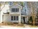 Charming two-story home featuring neutral siding, black shutters, and a welcoming front porch at 577 Woodbury, Pittsboro, NC 27312