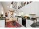 Bright kitchen with white cabinets, granite counters, and an antique sewing machine as decor leading to dining area at 577 Woodbury, Pittsboro, NC 27312
