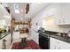 Well-lit kitchen showcasing white cabinetry, granite countertops, a skylight, and an antique sewing table at 577 Woodbury, Pittsboro, NC 27312