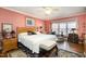 Bright main bedroom featuring hardwood floors, a queen bed, and a bay window with decorative curtains at 577 Woodbury, Pittsboro, NC 27312