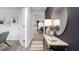 Inviting entryway with wood-look flooring, decorative console table with mirror, and view into the dining area at 5921 Sodium St, Raleigh, NC 27610