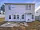 Back exterior view features a siding, multiple windows and a patio at 6025 Herston Rd, Raleigh, NC 27610