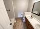 A well-lit bathroom with double sinks and wood cabinets at 6025 Herston Rd, Raleigh, NC 27610