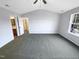 A spacious bedroom with a ceiling fan and views of a bathroom at 6025 Herston Rd, Raleigh, NC 27610