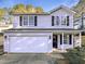 Charming two-story home with attached two-car garage and well-maintained front yard and a covered porch at 6025 Herston Rd, Raleigh, NC 27610