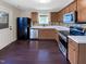 Functional kitchen with stainless steel appliances, wooden cabinets, and plenty of counter space at 6025 Herston Rd, Raleigh, NC 27610