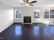 Spacious living room featuring dark hardwood floors, a fireplace and bright windows at 6025 Herston Rd, Raleigh, NC 27610