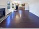 An open-concept living room flows into kitchen with hardwood floors and fireplace at 6025 Herston Rd, Raleigh, NC 27610
