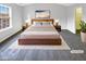 This main bedroom features neutral decor, a large bed, and a bright window at 6025 Herston Rd, Raleigh, NC 27610