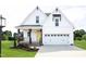 Charming two-story home with white siding, a yellow front door, and a well-manicured lawn at 619 Magnolia Acres Ln, Fuquay Varina, NC 27526
