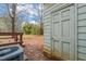 View of the backyard with deck, storage shed, and stone pavers at 621 Bashford Rd, Raleigh, NC 27606