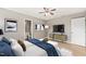 Comfortable bedroom featuring a ceiling fan, a television and a large white bench at the foot of the bed at 621 Bashford Rd, Raleigh, NC 27606