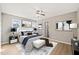 Comfortable bedroom with a ceiling fan, plush bedding, a rug and two bedside tables at 621 Bashford Rd, Raleigh, NC 27606
