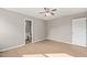 Neutral-toned bedroom with a ceiling fan and an en suite bathroom at 621 Bashford Rd, Raleigh, NC 27606