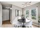 Cozy dining area featuring a ceiling fan, large window and a modern black table with white chairs at 621 Bashford Rd, Raleigh, NC 27606