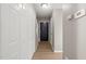 Well-lit hallway with wood-look flooring, ample closet space, and a neutral wall color at 621 Bashford Rd, Raleigh, NC 27606