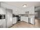Modern kitchen with stainless steel appliances and white cabinetry, designed for efficiency and style at 621 Bashford Rd, Raleigh, NC 27606