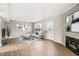 Bright living room with a fireplace, stylish furnishings, light gray colored walls and wood-look floors at 621 Bashford Rd, Raleigh, NC 27606