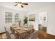 Formal dining room featuring a wooden table, six chairs, and natural light from nearby windows at 673 Beck Ave, Henderson, NC 27536