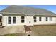 Back of house with a concrete patio and a well-maintained lawn at 70 Waterford Dr, Angier, NC 27501