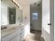 Bathroom with double vanity, large mirror, updated fixtures, and an alcove featuring the toilet and window at 70 Waterford Dr, Angier, NC 27501