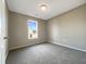Cozy bedroom featuring neutral carpeting and walls, and a window for natural light at 70 Waterford Dr, Angier, NC 27501