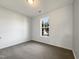 Bedroom featuring a large window offering lots of natural light and neutral walls and carpeting at 70 Waterford Dr, Angier, NC 27501