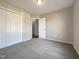 Bedroom featuring large closet doors, neutral carpeting, and a connecting door into another room at 70 Waterford Dr, Angier, NC 27501