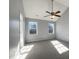Spacious bedroom featuring two windows providing lots of natural light and a ceiling fan at 70 Waterford Dr, Angier, NC 27501
