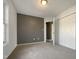 Neutral bedroom featuring a gray accent wall, natural light, and a closet with white doors at 70 Waterford Dr, Angier, NC 27501