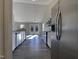 Bright kitchen features stainless steel appliances and white cabinets, with light shining through French doors at 70 Waterford Dr, Angier, NC 27501