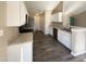 Well-lit kitchen featuring white cabinets and updated countertops at 70 Waterford Dr, Angier, NC 27501