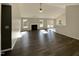 Open-concept living room with hardwood floors, fireplace, and natural light at 70 Waterford Dr, Angier, NC 27501