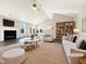 Bright living room featuring a fireplace, vaulted ceiling, and a cozy seating area at 70 Waterford Dr, Angier, NC 27501
