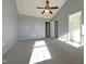 Empty primary bedroom with a vaulted ceiling, fan, and ensuite bath access at 70 Waterford Dr, Angier, NC 27501