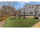 Backyard featuring an artificial turf lawn and outdoor exercise equipment at 729 Colby Pl, Durham, NC 27713