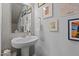 Stylish half bathroom with unique artwork, pedestal sink and modern finishes at 729 Colby Pl, Durham, NC 27713