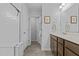Bright bathroom boasts a shower, a vanity with dark cabinets and a tiled floor at 729 Colby Pl, Durham, NC 27713