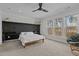 Spacious bedroom with many windows allowing ample natural light, ceiling fan, and accent wall at 729 Colby Pl, Durham, NC 27713