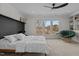 Bedroom with picture windows overlooking wooded backyard, a ceiling fan and built in shelving at 729 Colby Pl, Durham, NC 27713