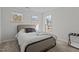 Cozy bedroom offers natural light from multiple windows and neutral decor at 729 Colby Pl, Durham, NC 27713