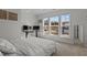 Bright bedroom featuring three large windows with outside views, a neutral color palette and a dedicated desk area at 729 Colby Pl, Durham, NC 27713