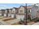 Row of cozy homes featuring two-car garages, gray siding, and well-manicured lawns at 729 Colby Pl, Durham, NC 27713