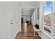 Bright hallway with hardwood floors leading to the dining area with natural light at 729 Colby Pl, Durham, NC 27713