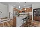 Modern kitchen featuring a central island, stainless steel appliances, and elegant pendant lighting at 729 Colby Pl, Durham, NC 27713